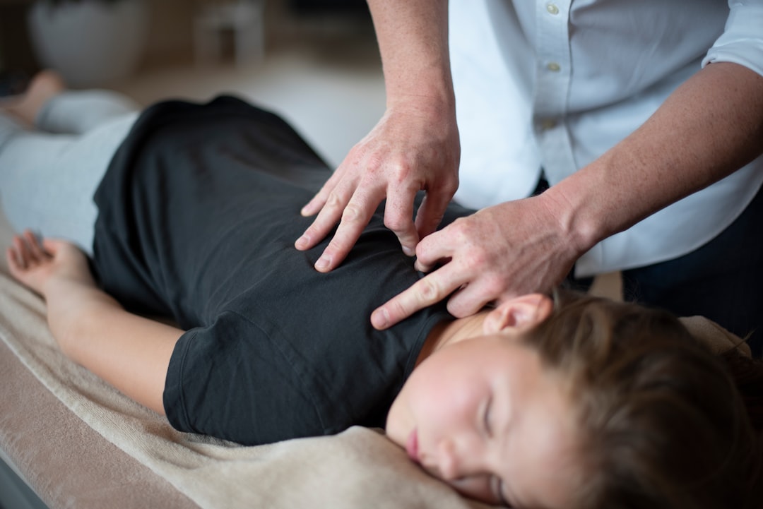 Chiropractor performing spinal adjustment