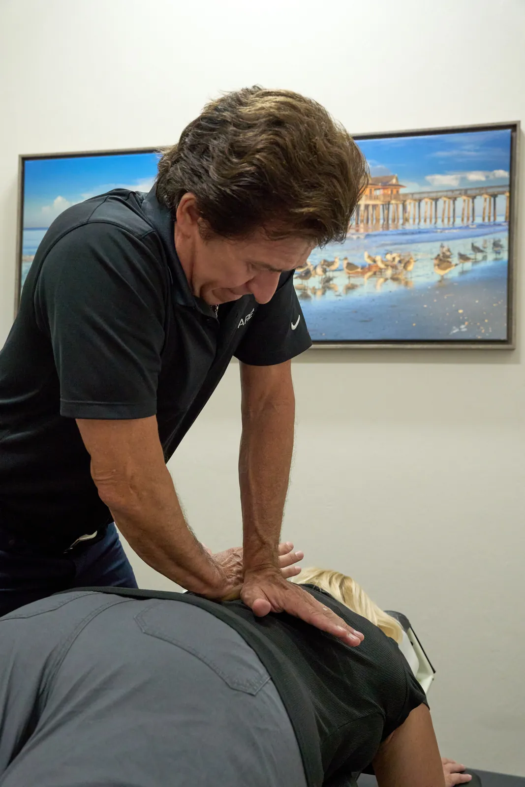 Dr. Ivan performing manual therapy back treatment at Novaré