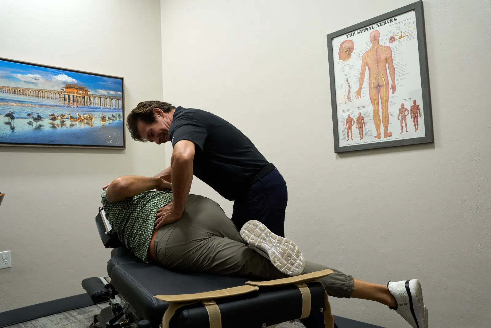 Dr. Ivan performing a manual spinal adjustment at Novaré Injury Care