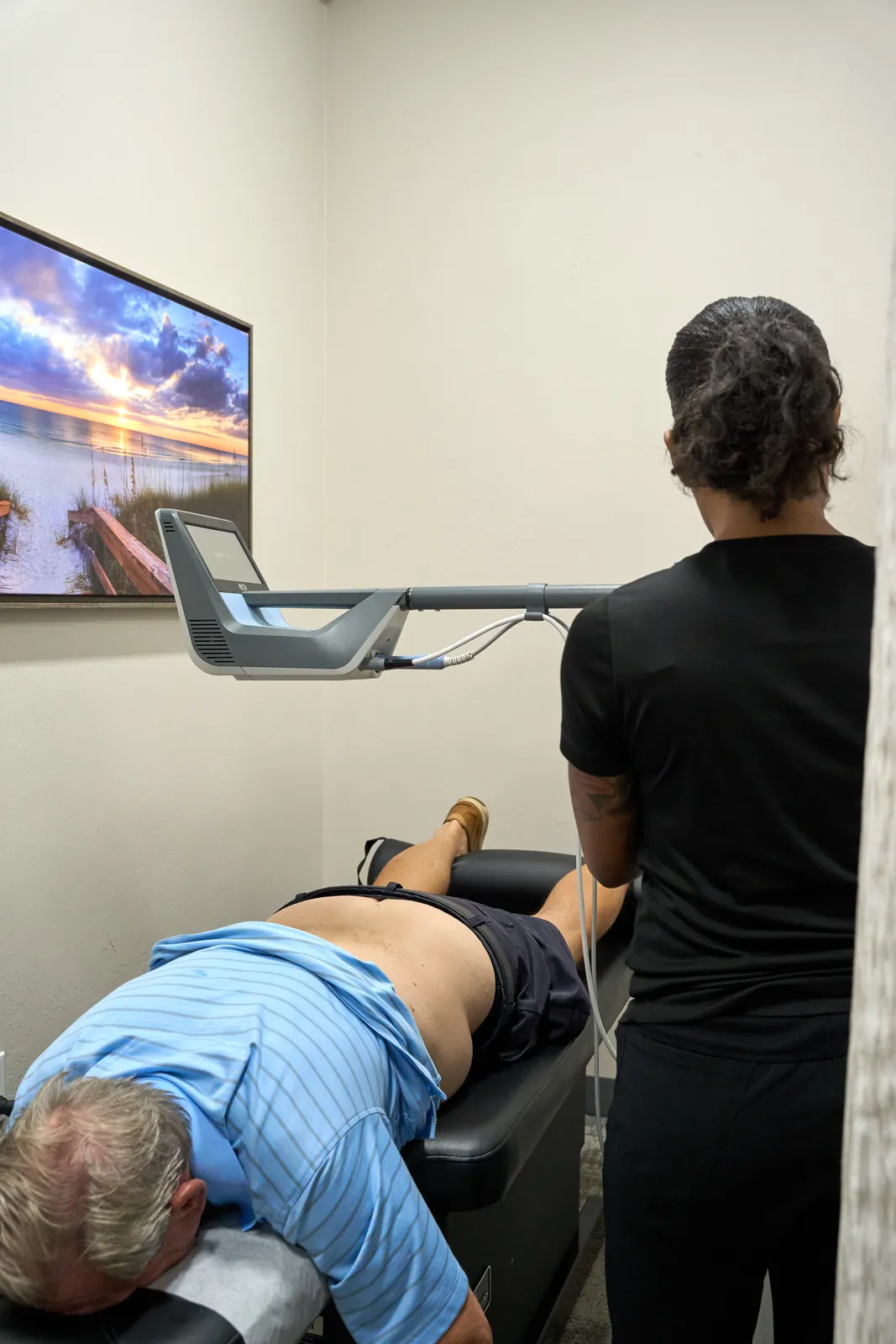Dr. Ivan presenting treatment rooms at Novaré Injury Care